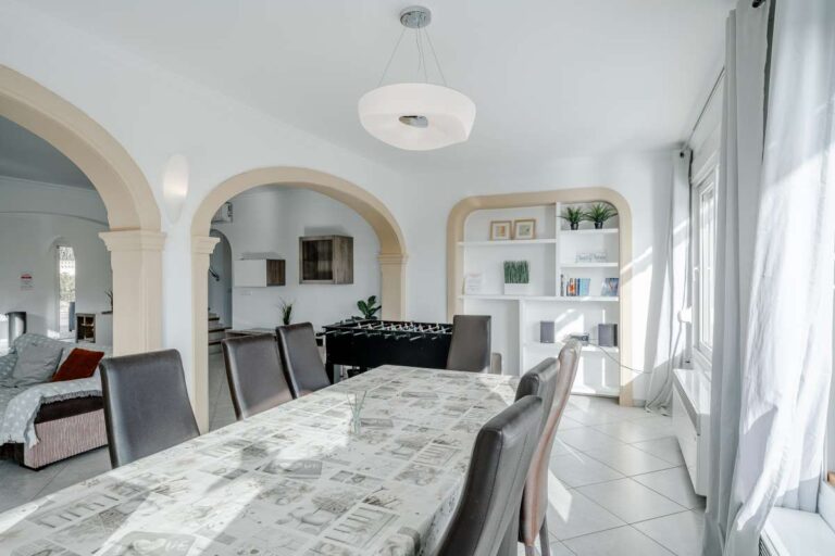 Bright dining area in a Calpe villa with arched openings leading into the living room