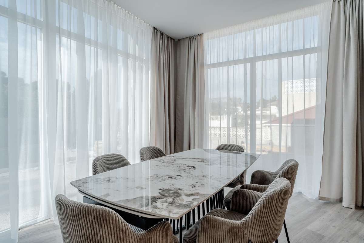 Bright dining area with large windows and natural light inside a new build villa for sale in Calpe