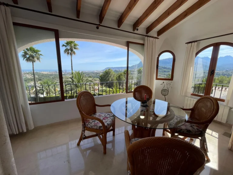 Bright dining area with sea, mountain, and valley views inside a villa in Calpe.