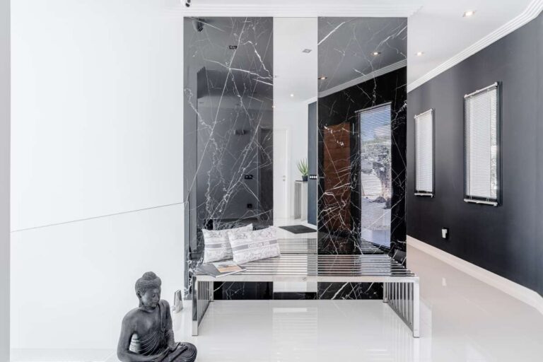 Bright entrance hall with marble staircase, glass lift and contemporary finishes inside a luxury villa in Gran Sol, Calpe.