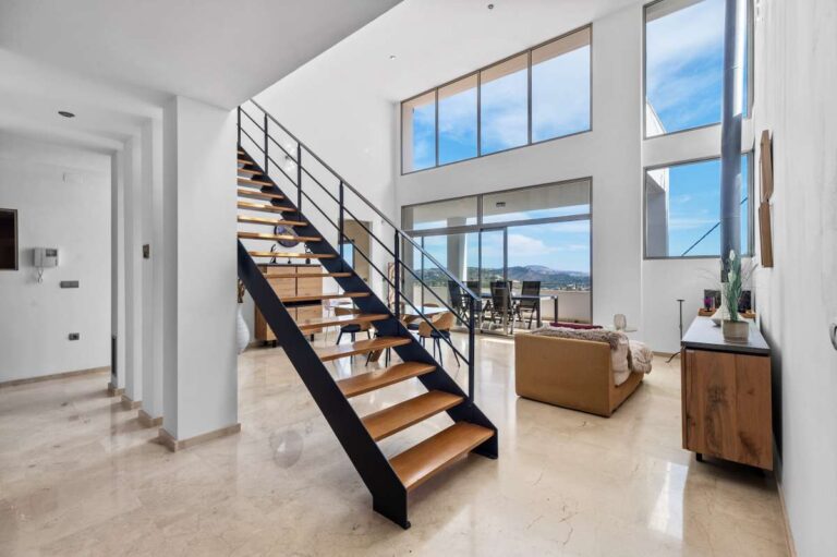 Bright entrance hall with staircase and large windows inside a modern spacious villa with panoramic sea views in Calpe.