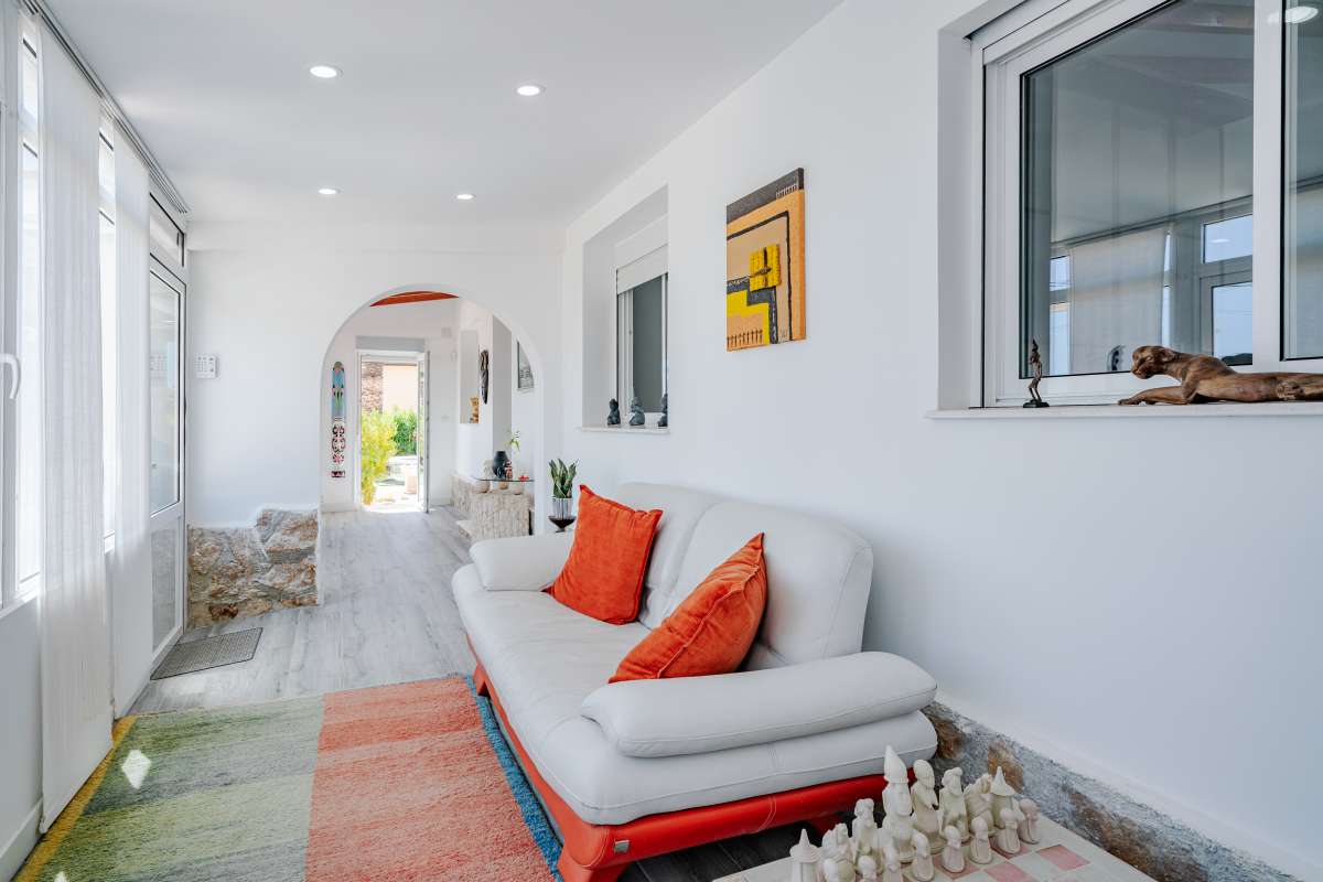 Bright glazed lounge with seating and natural light inside a renovated Mediterranean villa in La Cometa, Calpe.