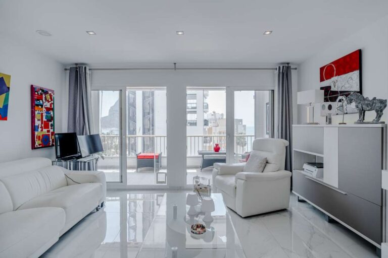 Bright living room inside a renovated apartment by Arenal-Bol Beach in Calpe with terrace access and modern interior design