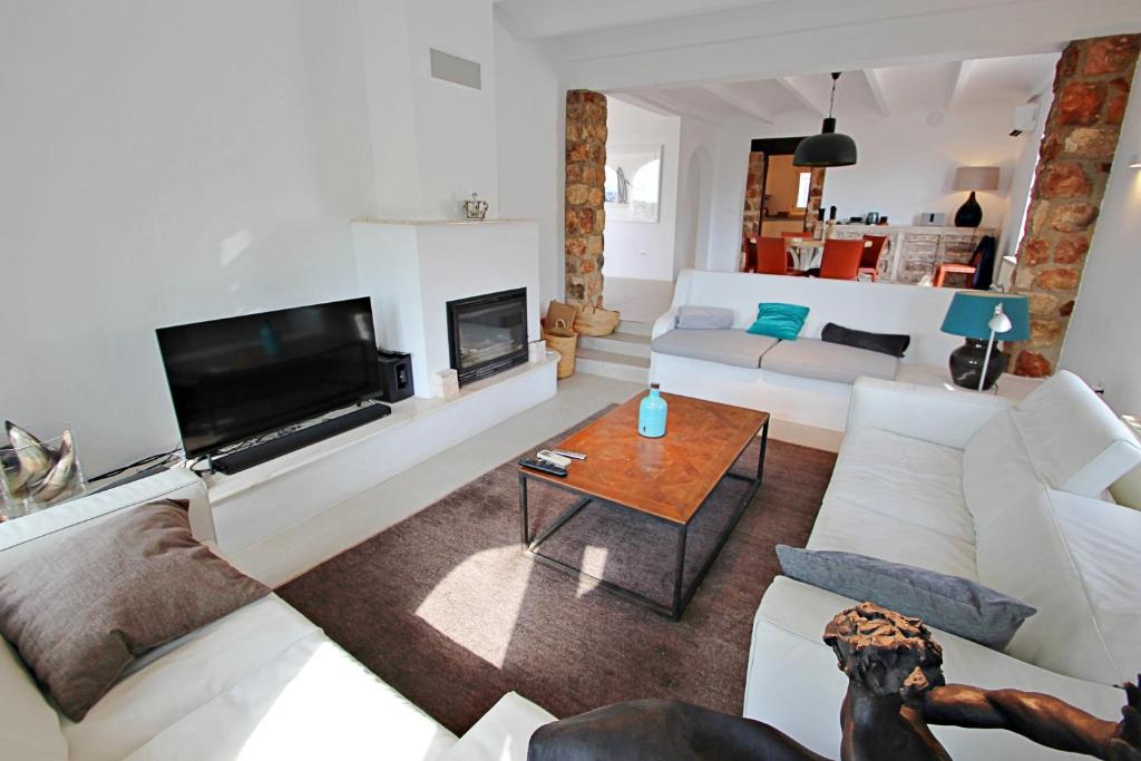 Bright living room with fireplace and open-plan layout at villa in Moraira