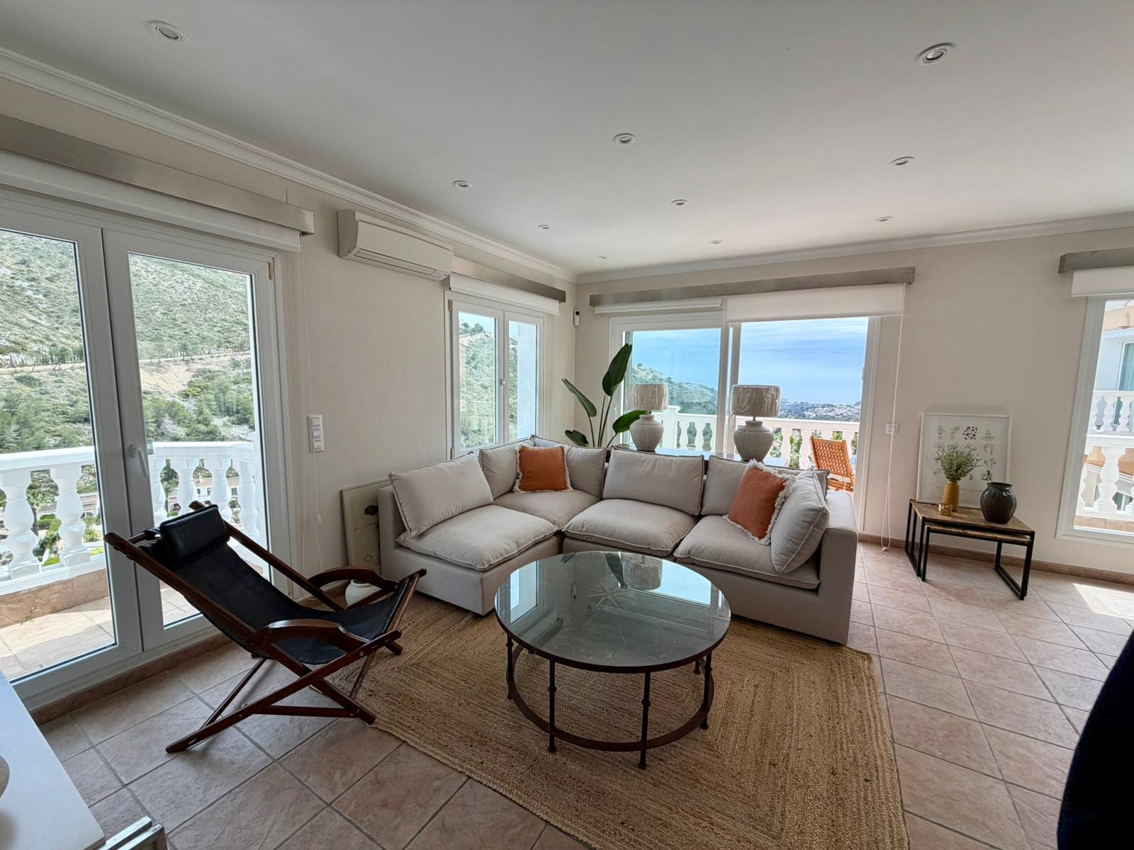 Bright living room with sea views at modern three-level villa in Moraira