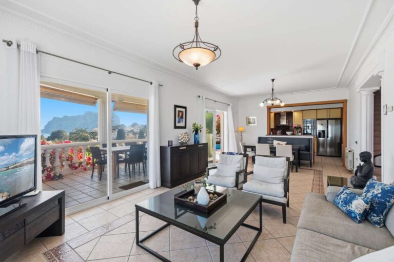 Bright living room with terrace access and sea views inside a villa in Calpe.