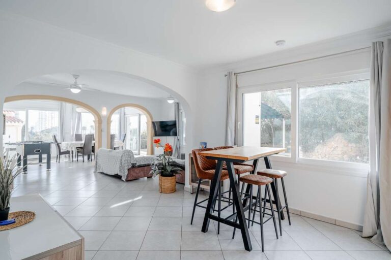 Bright open-plan living and dining area inside a villa for sale in Calpe