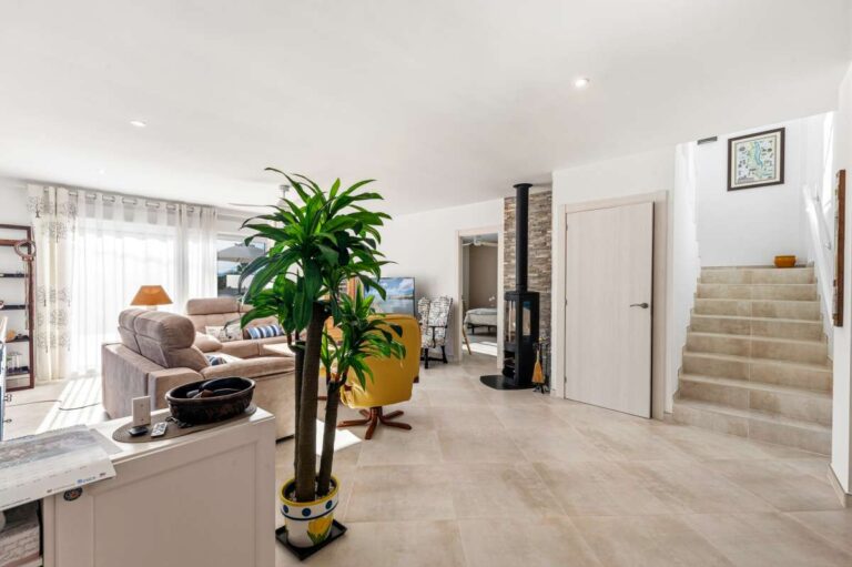 Bright open-plan living area with staircase and modern interior inside a contemporary villa in Calpe.