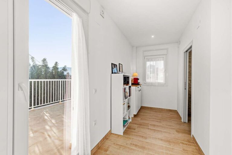 Bright upper floor hallway with access to a sunny terrace at a contemporary villa in Calpe.