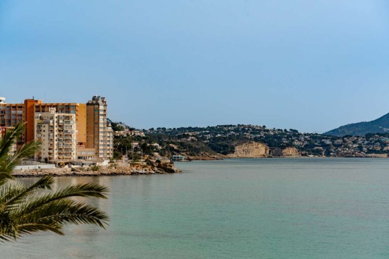 Coastal views from a beachfront apartment by La Fossa Beach in Calpe showing the Mediterranean Sea, nearby buildings and distant hills