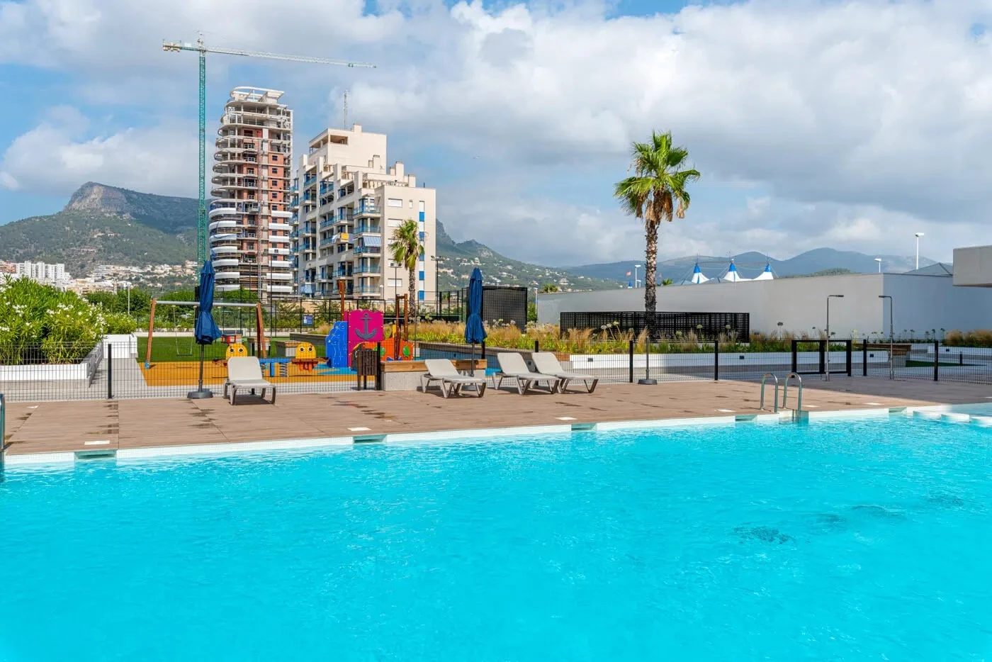 Communal pool and children’s play area at apartment complex in Arenal-Bol, Calpe