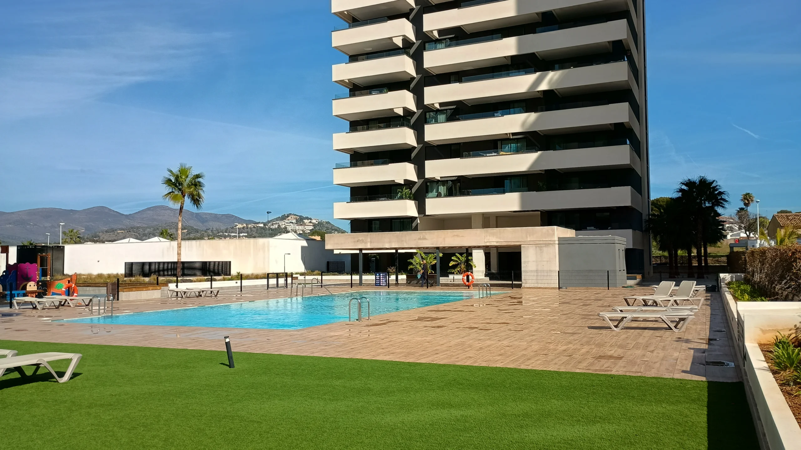Communal pool and gardens at modern luxury penthouse complex in Calpe