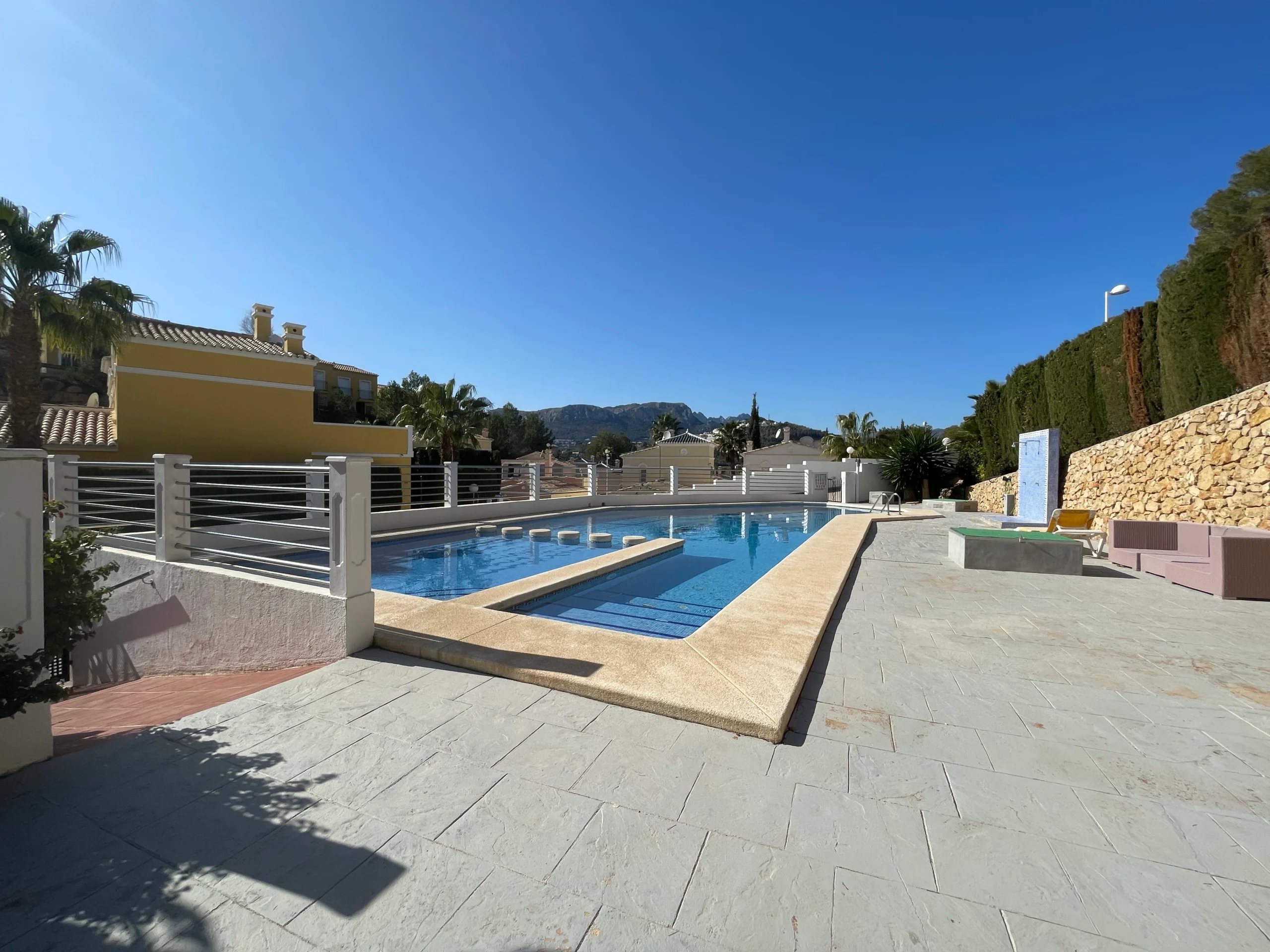 Communal pool terrace with mountain views in Calpe residential complex