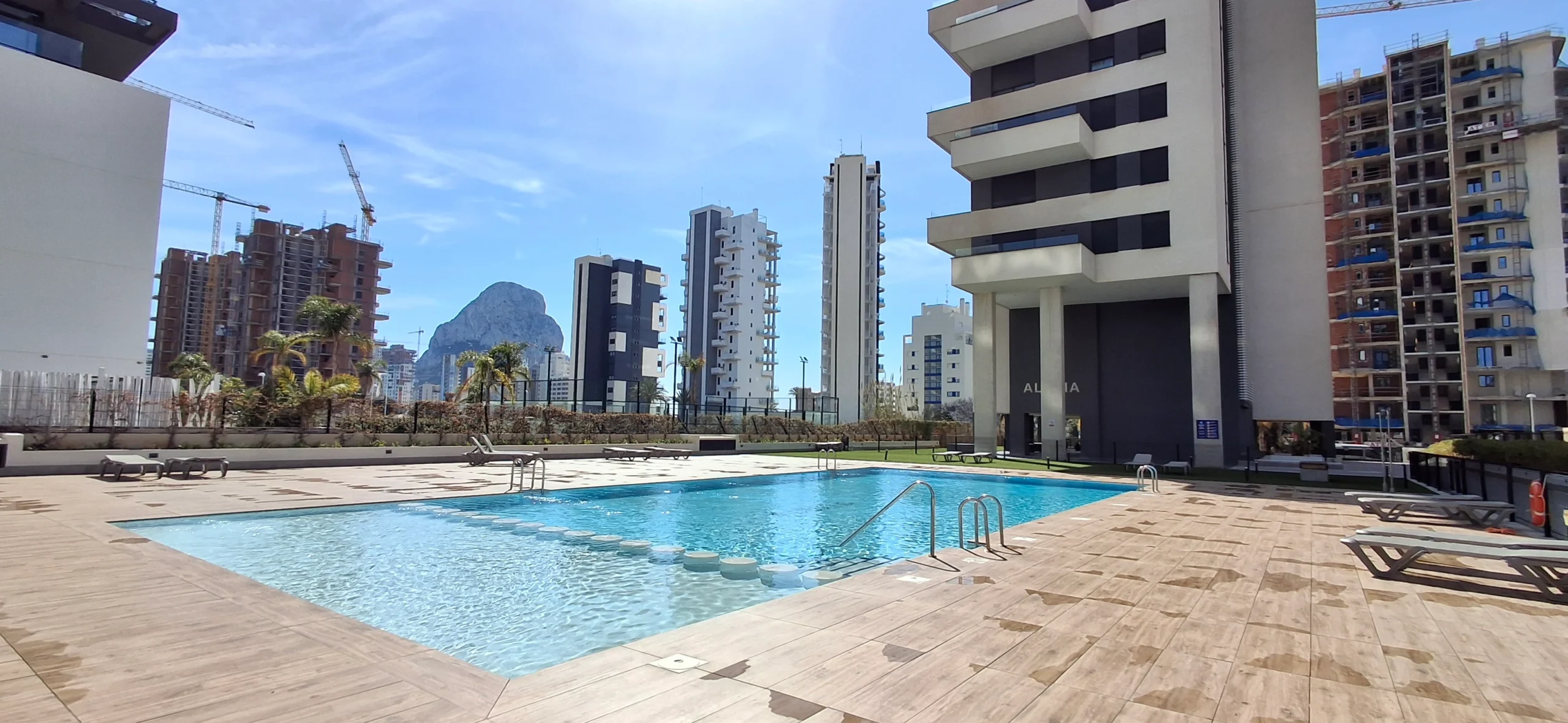 Communal pool with views towards the Peñón de Ifach at penthouse complex in Calpe