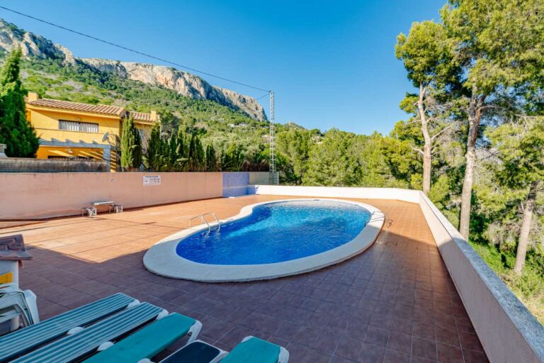Communal swimming pool near a semi-detached house in Calpe with sun terrace, loungers and mountain views