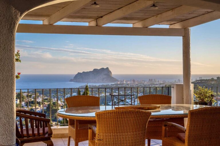 Covered dining terrace at a Benissa sea view villa with outdoor table, Mediterranean Sea views and the Peñón de Ifach in the distance