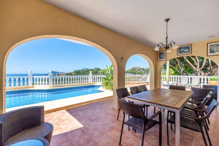Covered dining terrace at an Altea Hills villa with outdoor table, private pool views and panoramic Mediterranean Sea views