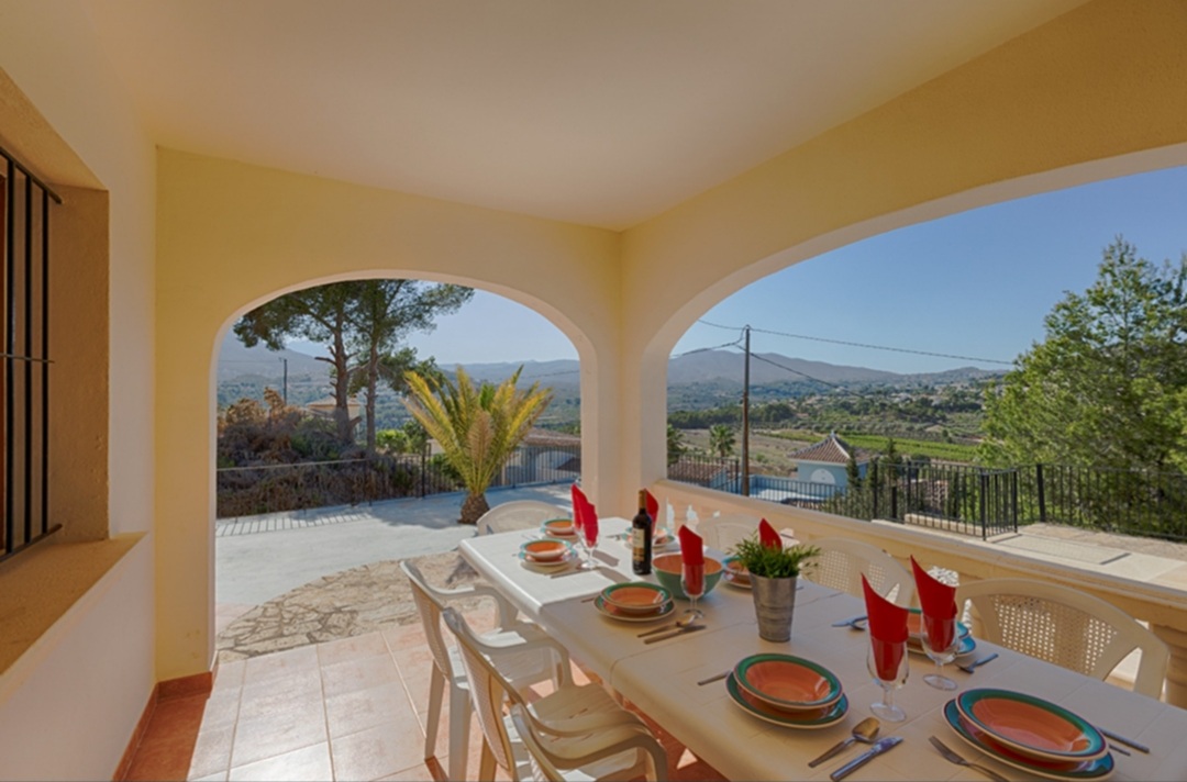 Covered dining terrace with mountain views at a Mediterranean villa in Calpe.