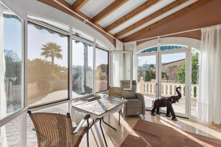 Covered naya with seating area at a single-level villa in Calpe close to beaches and amenities.