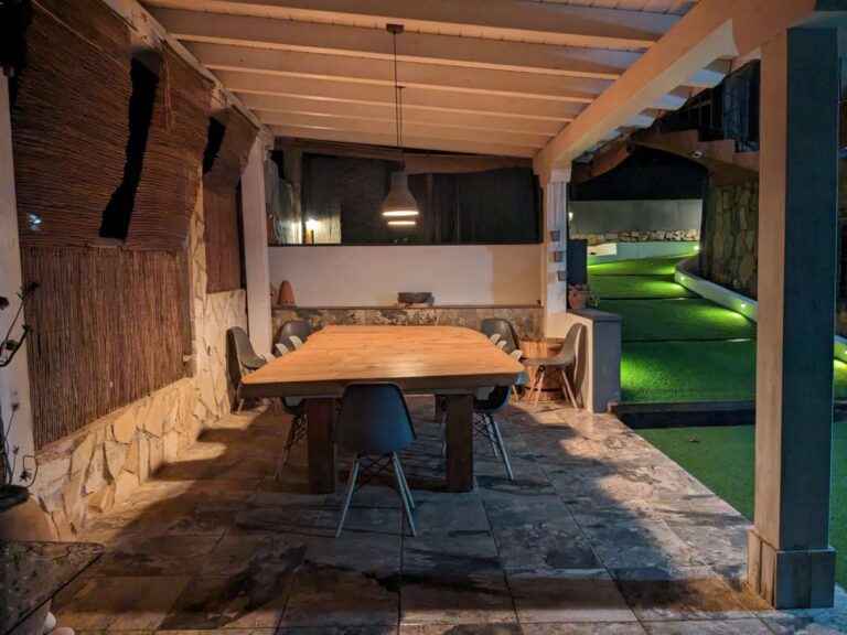 Covered outdoor dining area at night beside the pool at a refurbished villa in Canuta, Calpe.