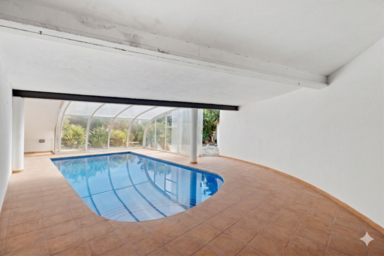 Covered swimming pool at a Mediterranean villa in Benissa Costa with tiled terrace, enclosed pool structure and renovation potential