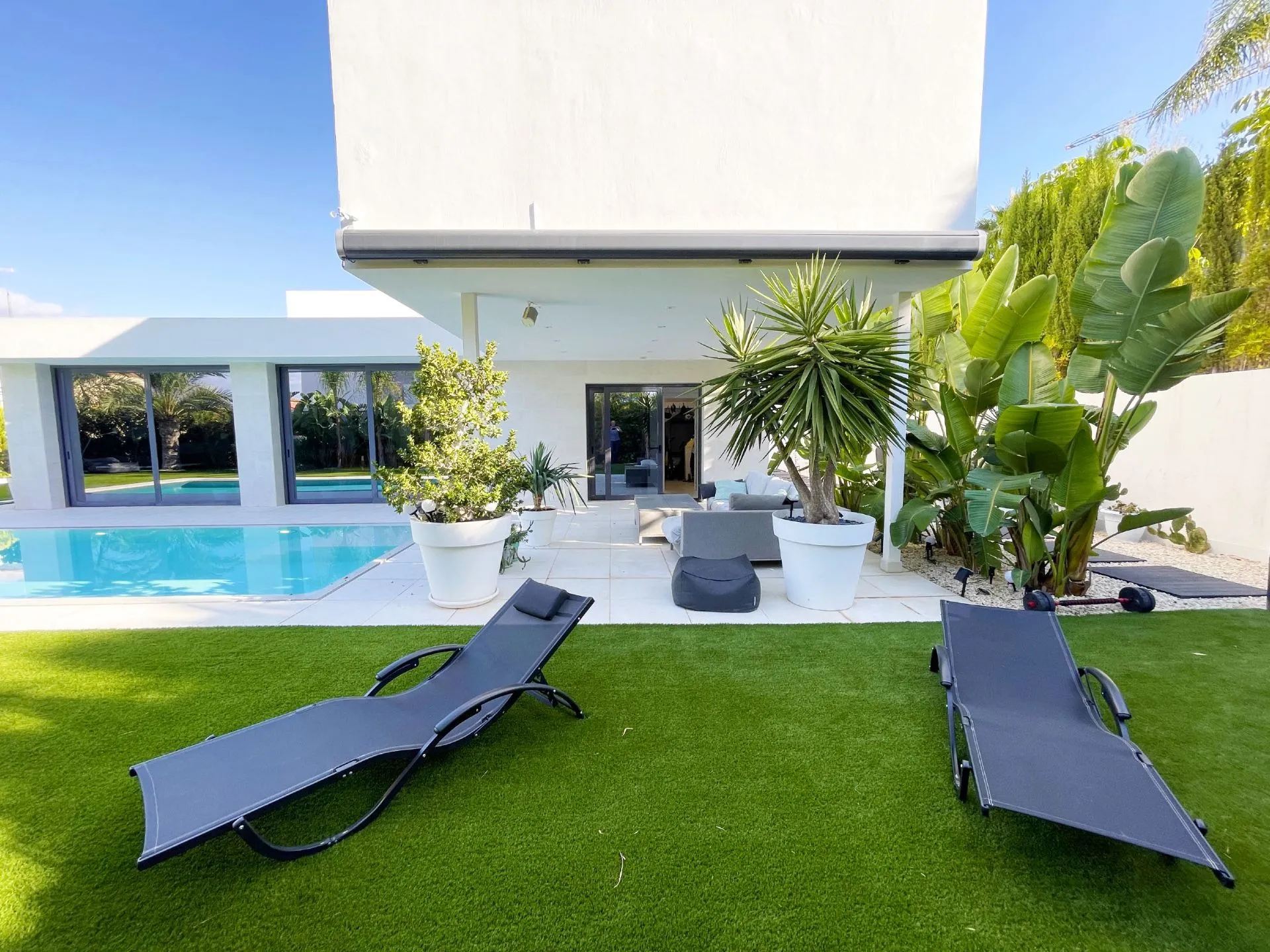 Covered terrace and pool area at modern villa in Calpe
