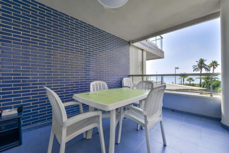 Covered terrace at a beachfront apartment in La Fossa, Calpe with outdoor dining space and sea views