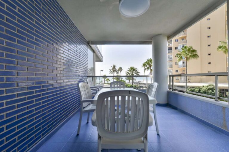 Covered terrace at a beachfront apartment in La Fossa, Calpe with outdoor dining space and views towards the sea