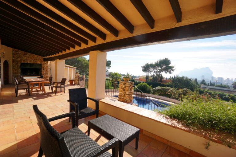 Covered terrace at a Mediterranean villa in Calpe with outdoor seating, pool views and views towards the Peñón de Ifach