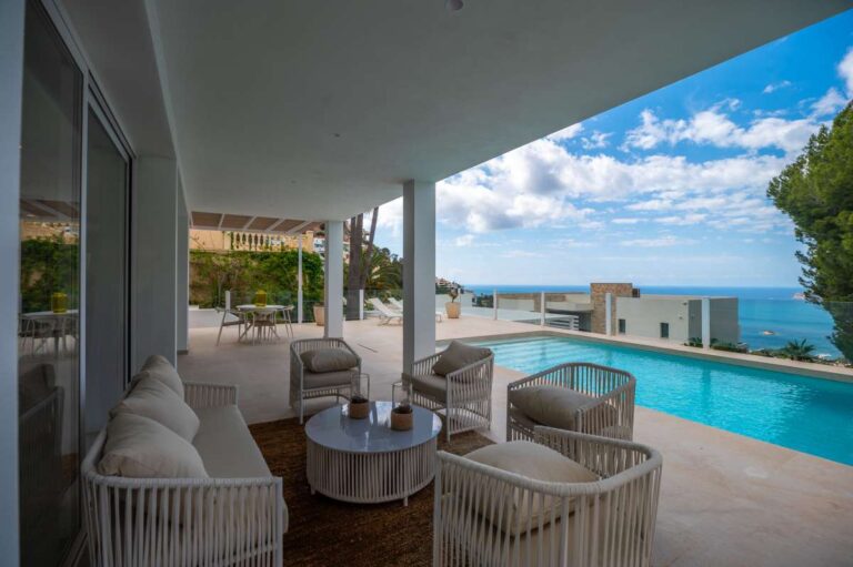 Covered terrace at a modern villa in Altea Hills with outdoor seating, private pool views and panoramic Mediterranean Sea views