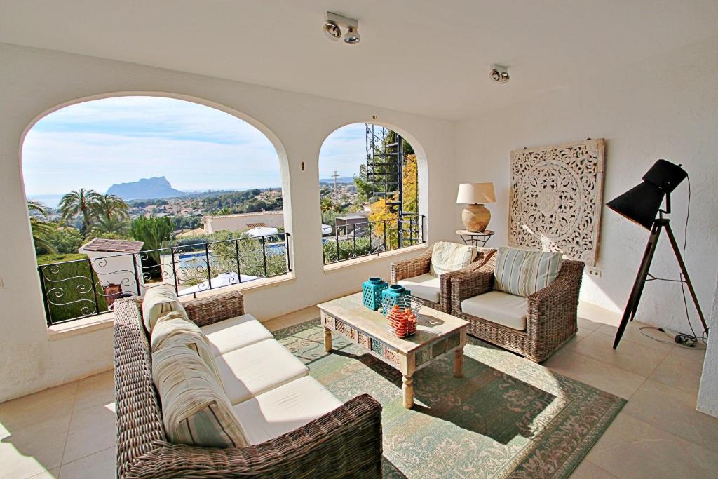 Covered terrace lounge with views towards the Peñón de Ifach in Moraira