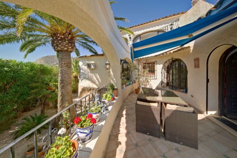 Covered terrace walkway with Mediterranean arches and garden views at a second line villa near Puerto Blanco in Calpe.