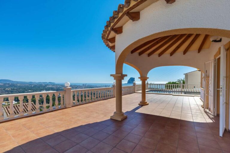 Covered terrace with arches and sea views at a villa in Calpe.