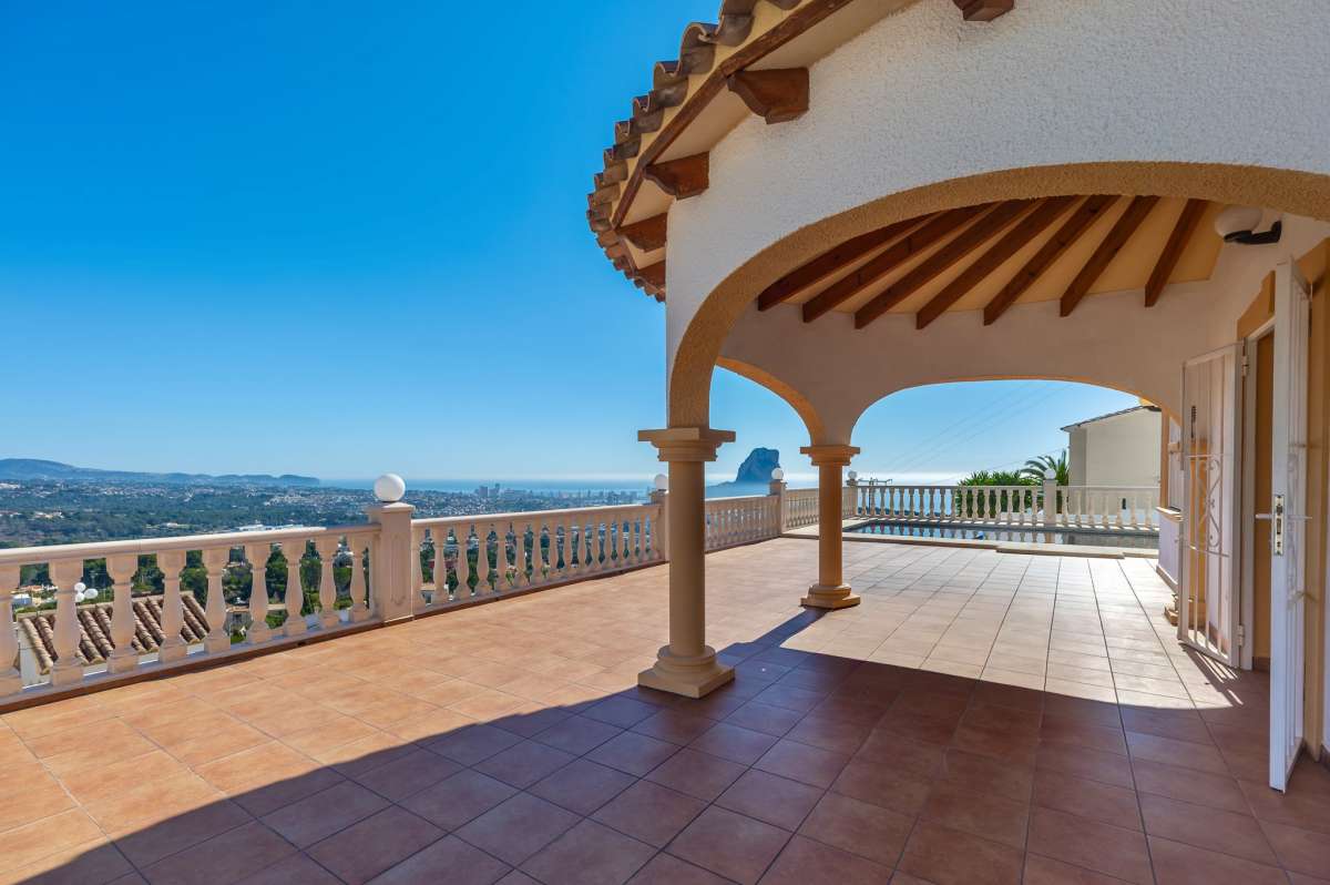 Covered terrace with arches and sea views at a villa in Calpe.