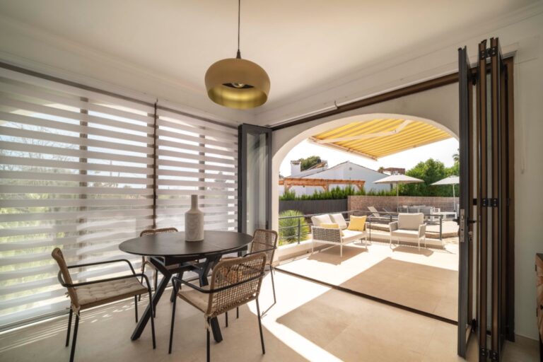 Covered terrace with dining area at Ibiza-style villa in Calpe