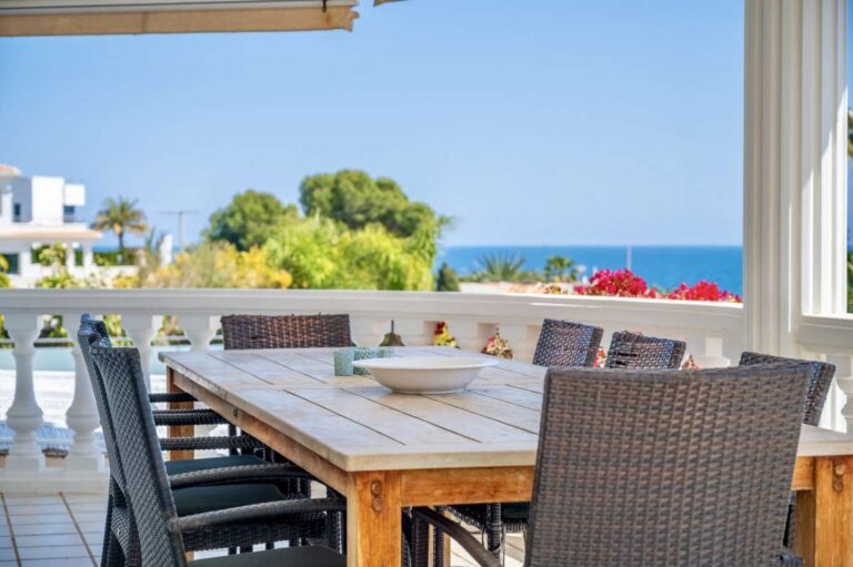 Covered terrace with outdoor dining space and open views at a villa in Calpe.