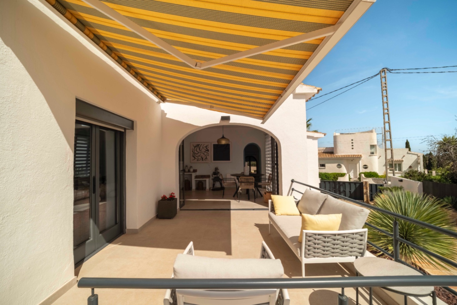 Covered terrace with outdoor seating at Ibiza-style villa in Calpe