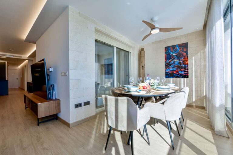 Dining and lounge area inside a luxury frontline beach duplex in Mascarat, Altea with terrace access, sea views and modern open-plan layout