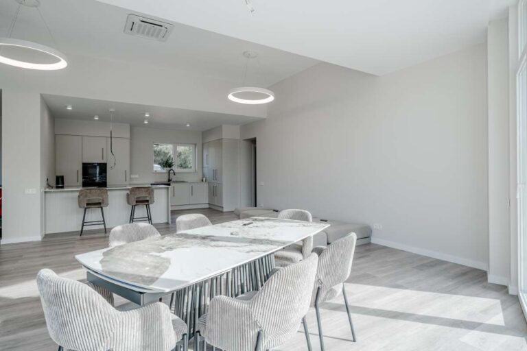 Dining area with open plan kitchen inside a new build villa for sale in Calpe near the coast