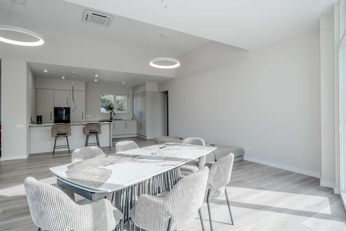 Dining area with open plan kitchen inside a new build villa for sale in Calpe near the coast