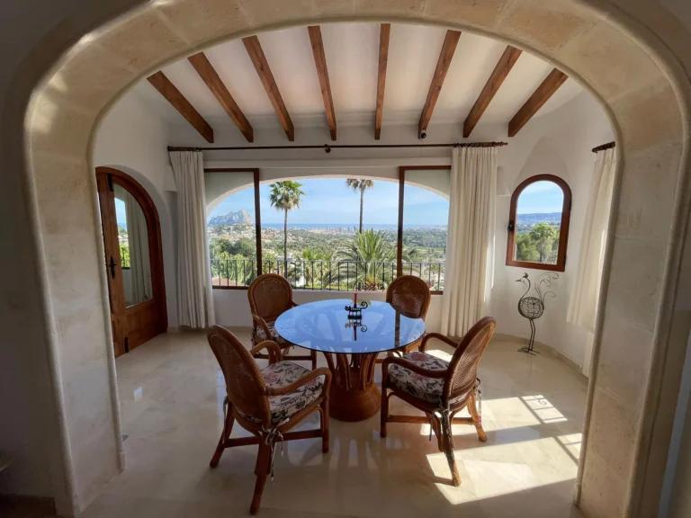 Dining area with panoramic sea and mountain views inside a villa in Calpe.
