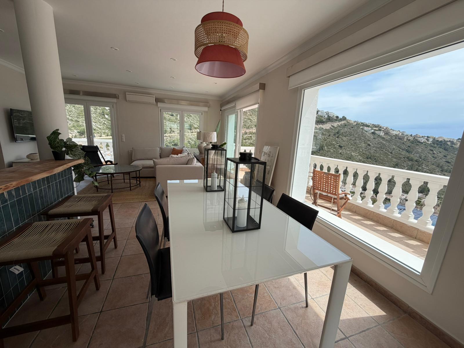 Dining area with sea and valley views at modern villa in Moraira