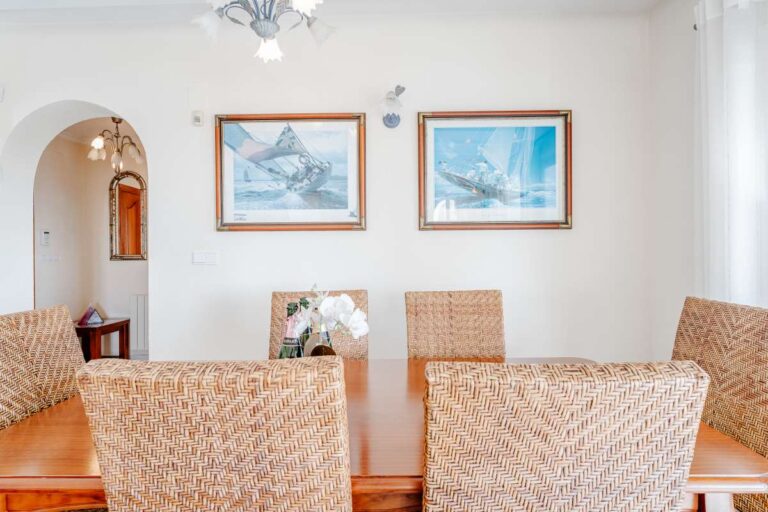 Dining area with traditional furniture and arched doorway inside a Mediterranean villa in Calpe.