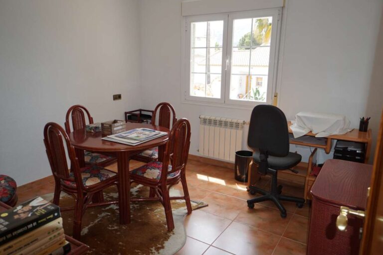 Dining area with traditional furniture inside a Mediterranean villa in Calpe, within a 10-minute walk of La Calalga Beach.