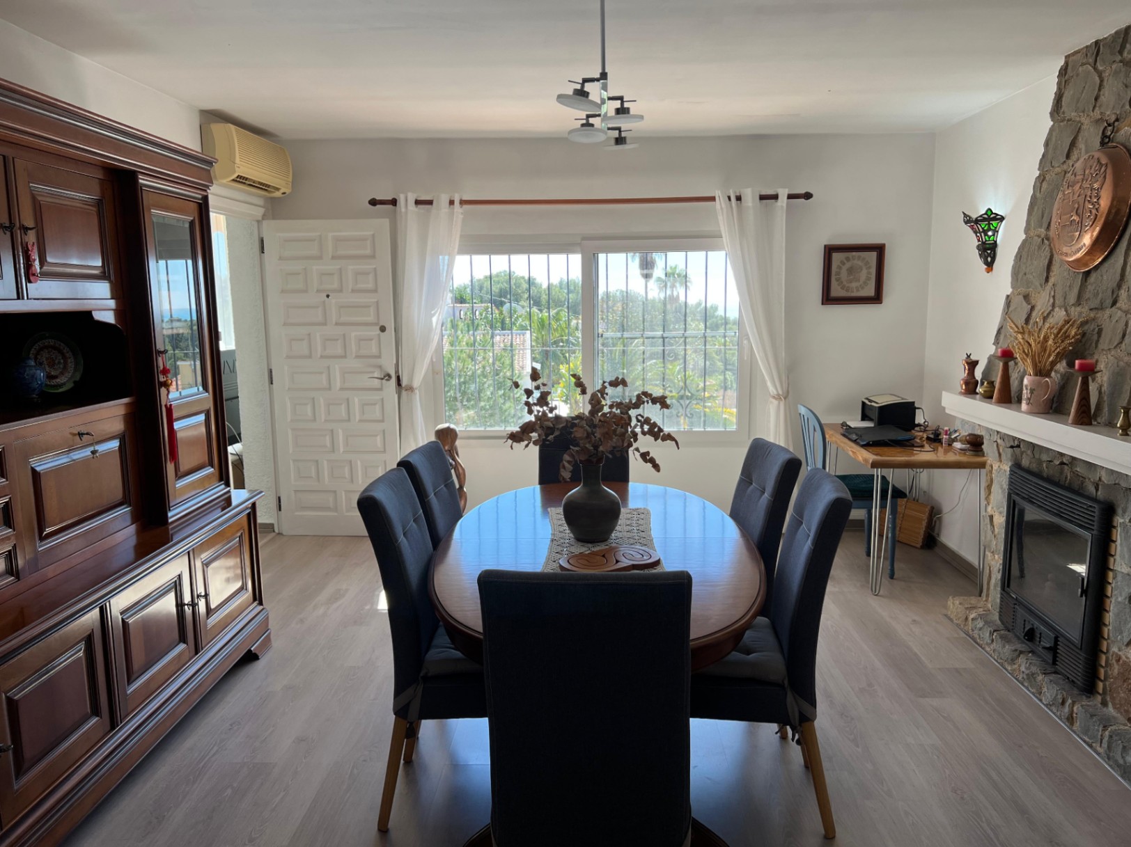 Dining room with fireplace at Mediterranean villa in Buena Vista Benissa