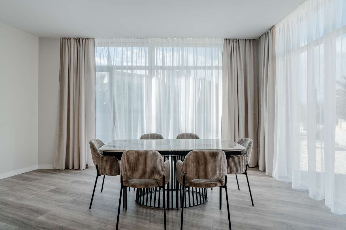 Dining room with large windows and garden views inside a modern new build villa in Calpe