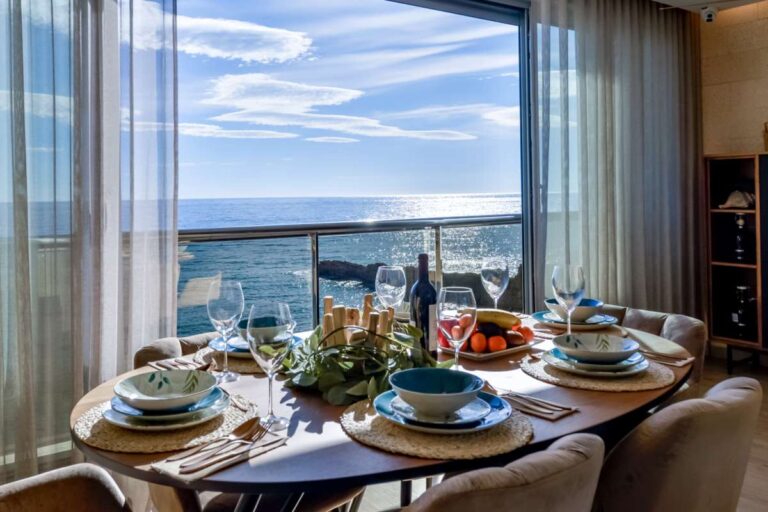 Dining table inside a luxury frontline beach duplex in Mascarat, Altea with direct sea views, natural light and beachfront terrace access