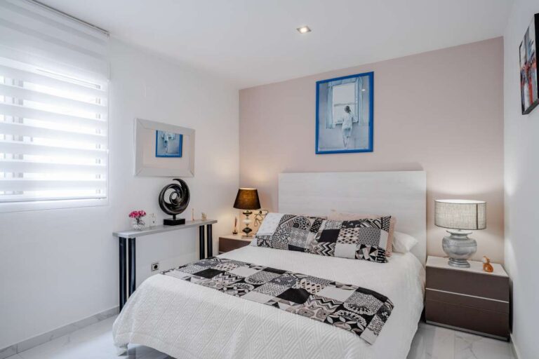 Double bedroom inside a renovated apartment in Arenal-Bol, Calpe with natural light, modern furniture and bright interior finish