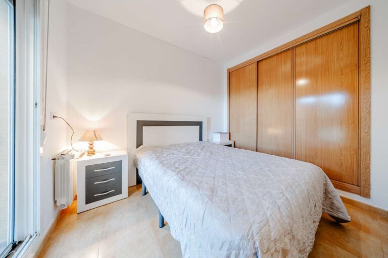 Double bedroom inside a semi-detached house in Calpe with built-in wardrobes, bedside tables and natural light