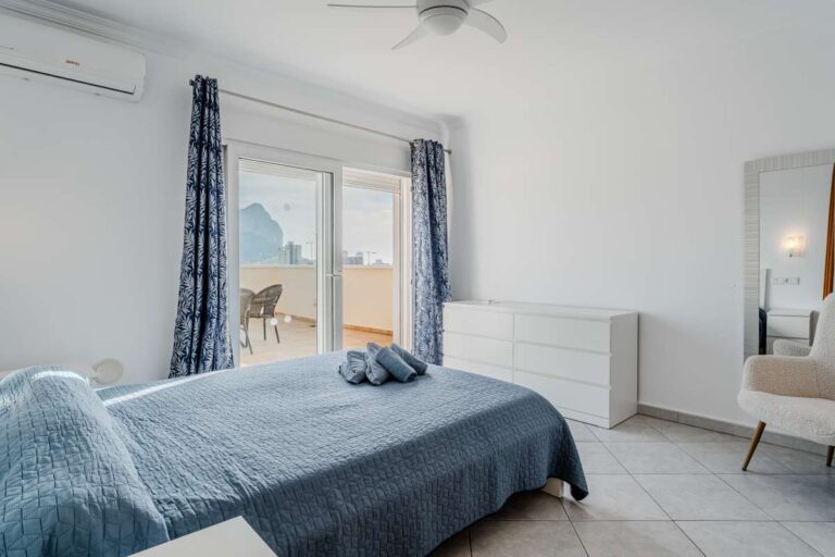 Double bedroom inside a villa in Calpe with terrace access, natural light and views towards the Peñón de Ifach